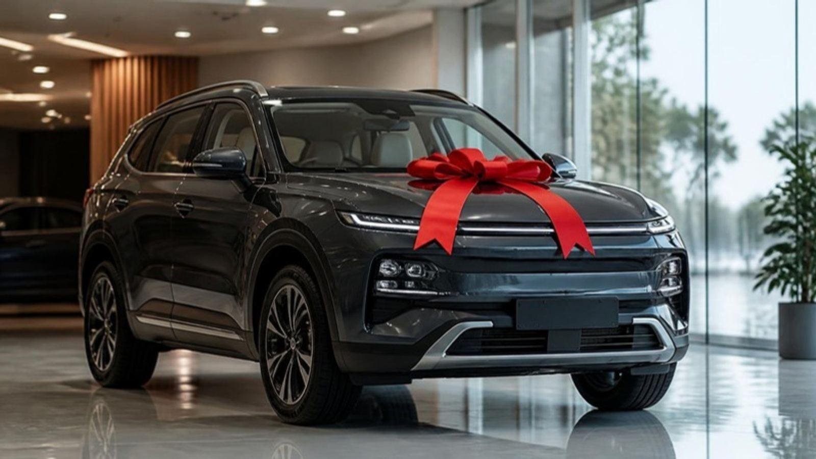 A brand-new SUV with a red ribbon bow in a bright showroom